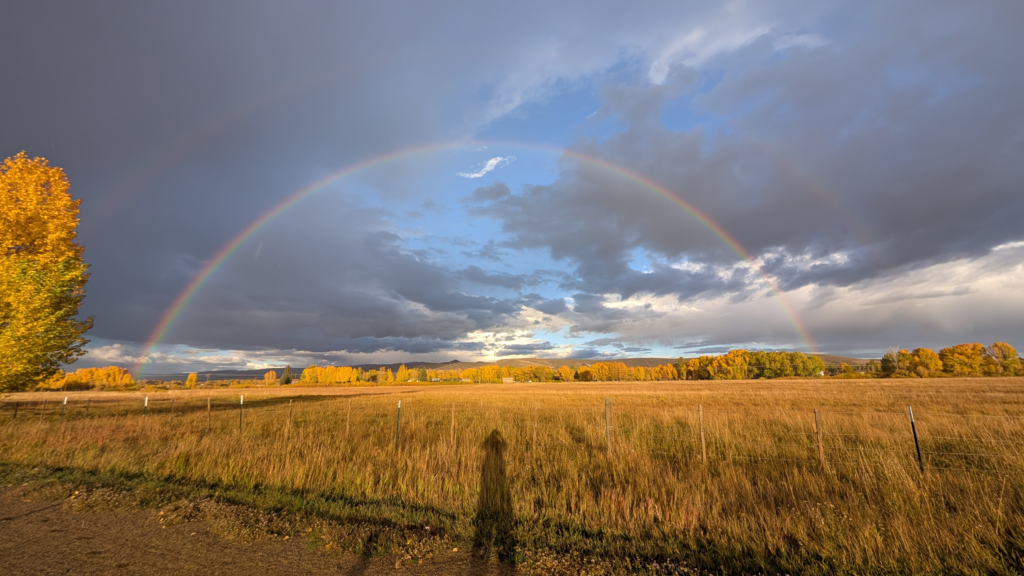 Ranch land at Van Tuyl loop with a rainbow in the Gunnison Valley